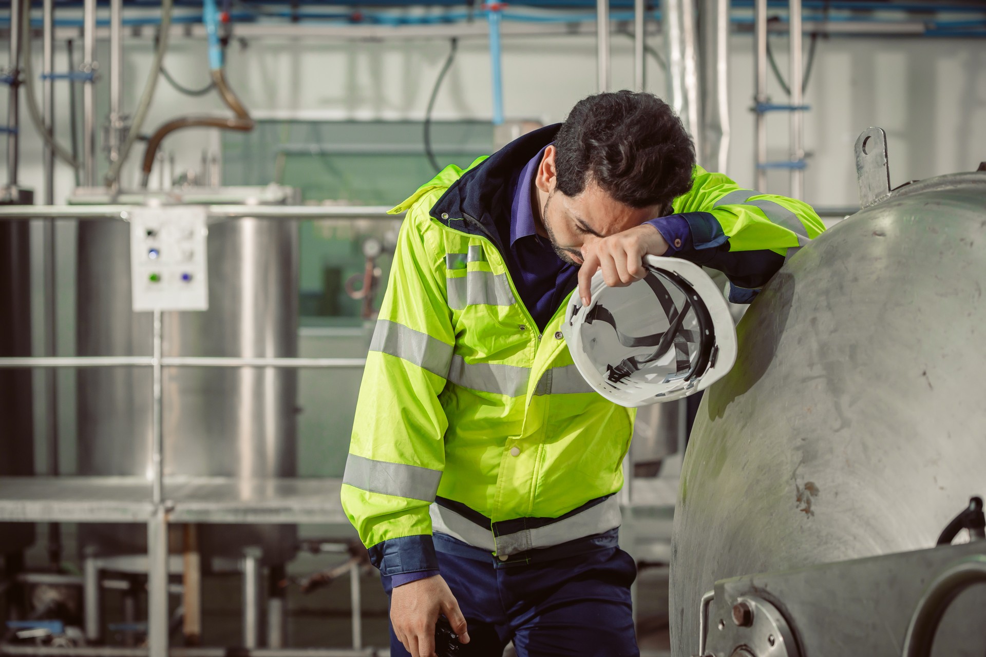 tired fatigue exhaustion engineer worker hard working in factory. worker sick from Corona virus flu.